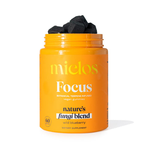 A jar of Mielos Botanical Terpene Infused Gummies, with a label indicating it is a 60-pack of gummies designed to support focus and wellness, featuring a dark-colored supplement inside.