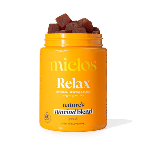 A jar of Mielos Botanical Terpene Infused Gummies, with a label indicating it is a 60-pack of gummies designed to support focus and wellness, featuring a dark-colored supplement inside.