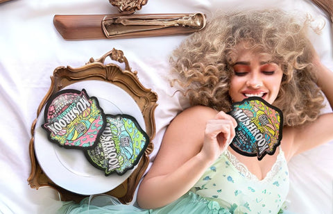 Woman holding colorful patches with Tre House 'Mushroom' Gummies - Alpha Fungi