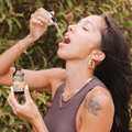 Woman taking daily dose of Alpha Fungi Lion's Mane liquid extract drops 